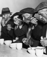 The Great Depression in the U.S.- Men eating bread and soup in a breadline. Undated photograph 1929-39